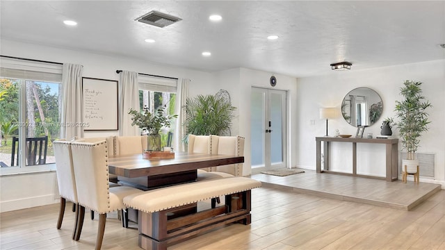 dining room featuring light wood-type flooring and french doors