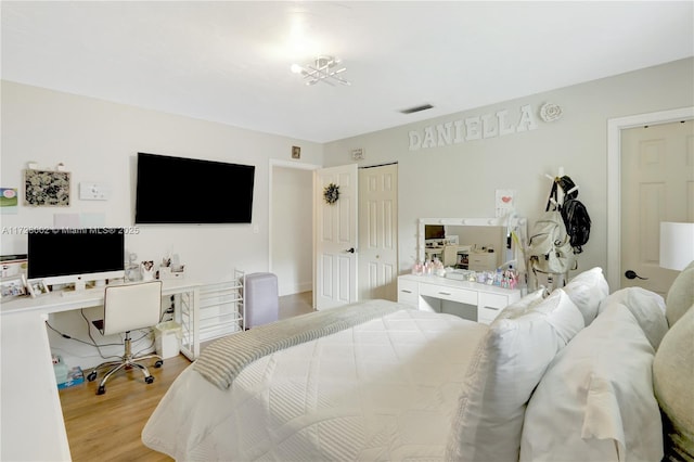 bedroom featuring a closet and light hardwood / wood-style flooring