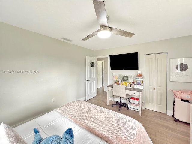 bedroom with ceiling fan, a closet, and light wood-type flooring