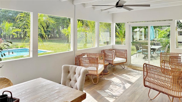 sunroom featuring ceiling fan and beam ceiling