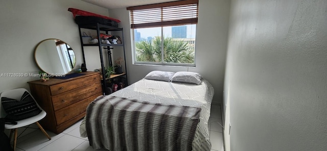 bedroom featuring light tile patterned floors and multiple windows