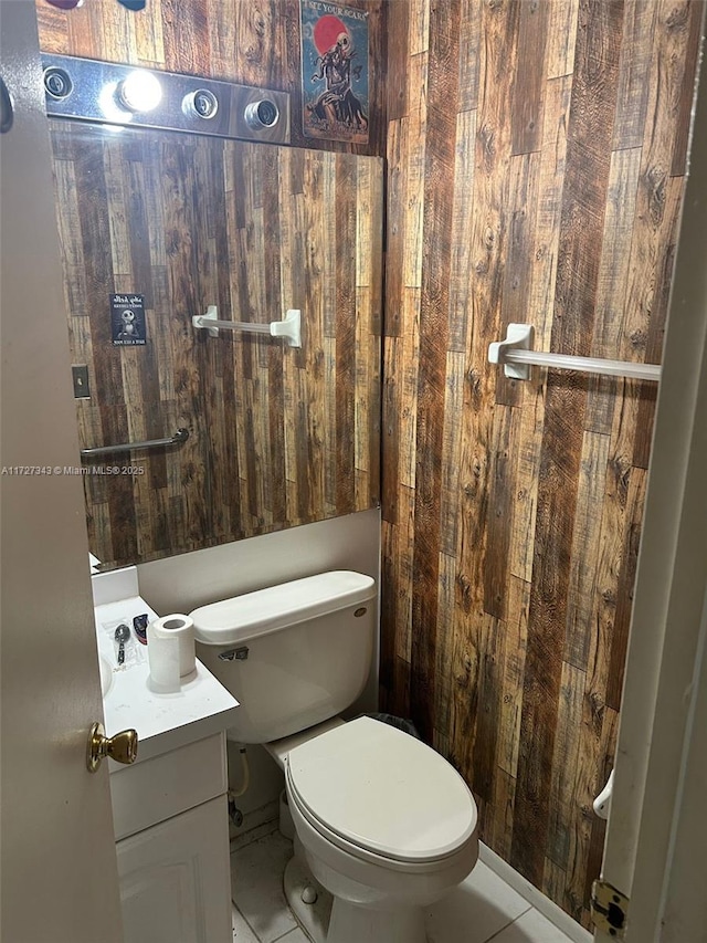 bathroom with tile patterned flooring, vanity, and toilet