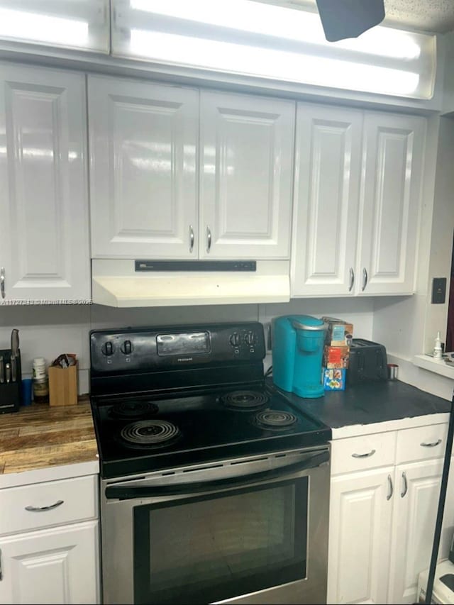 kitchen featuring white cabinetry and stainless steel electric range