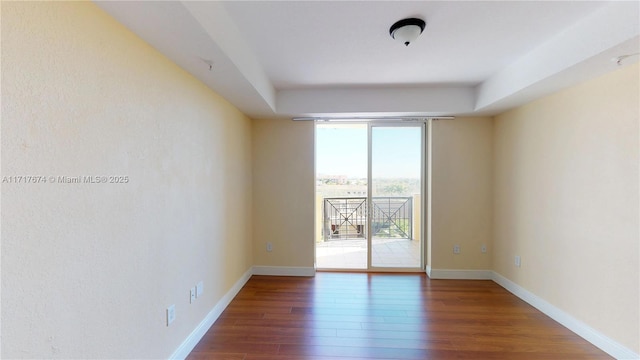 empty room featuring dark hardwood / wood-style flooring