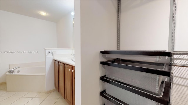 bathroom featuring a bathtub, tile patterned floors, and vanity