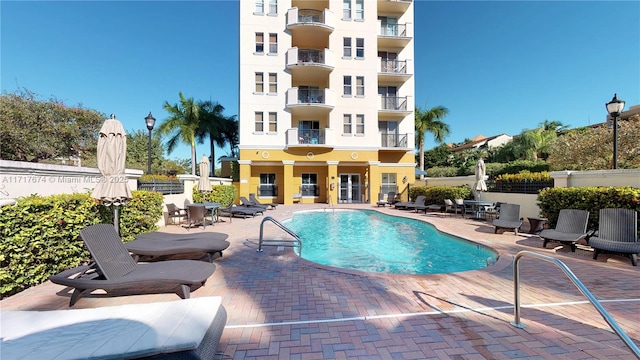 view of swimming pool with a patio