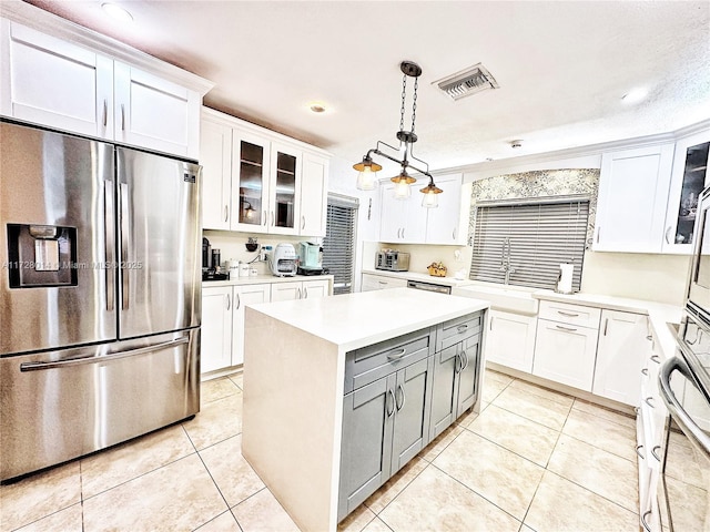 kitchen with appliances with stainless steel finishes, a center island, white cabinetry, hanging light fixtures, and gray cabinetry