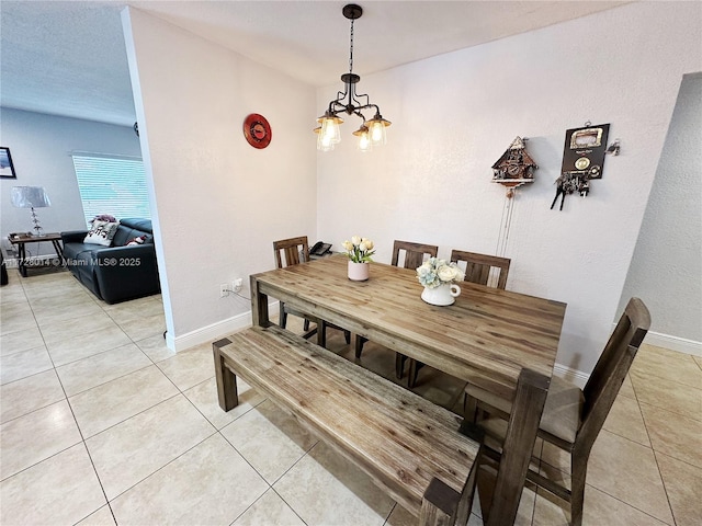 dining area featuring an inviting chandelier and light tile patterned flooring