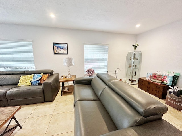 living room featuring a wealth of natural light and light tile patterned floors