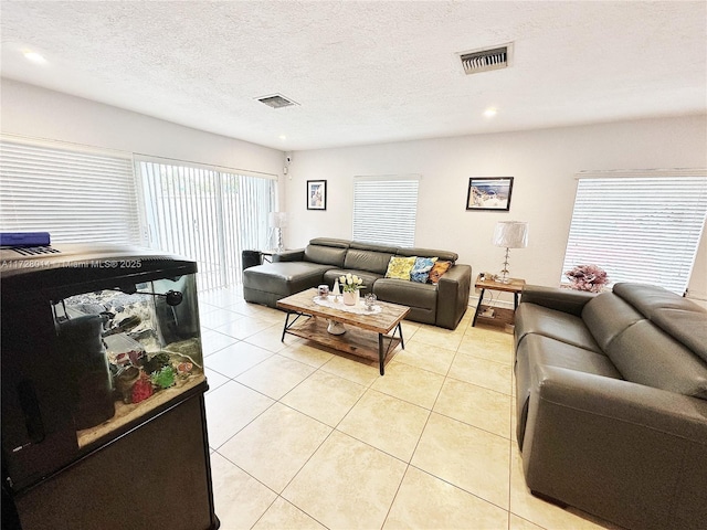 tiled living room with a textured ceiling