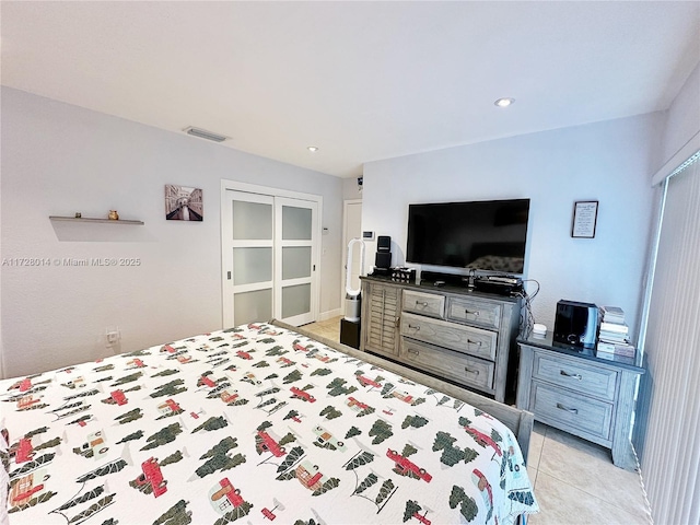 bedroom featuring light tile patterned floors and a closet