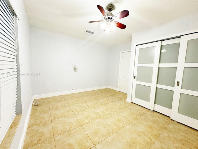 unfurnished bedroom featuring ceiling fan and light tile patterned flooring