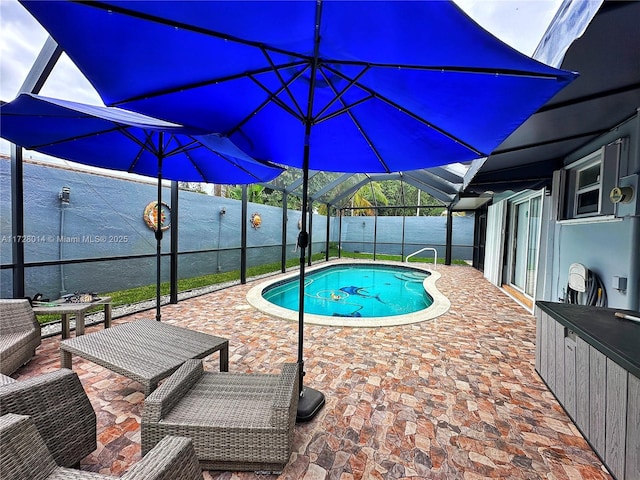 view of pool featuring a lanai and a patio