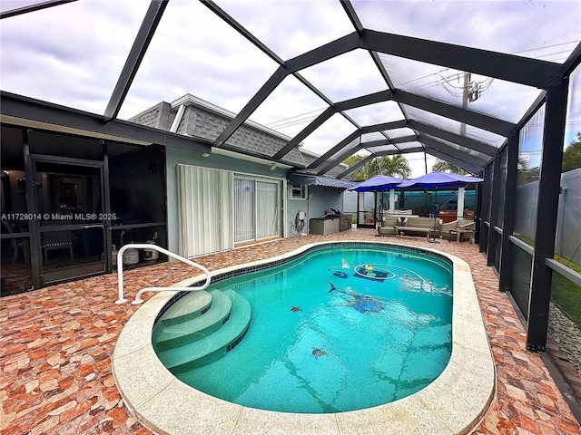 view of swimming pool featuring glass enclosure, a patio area, and outdoor lounge area