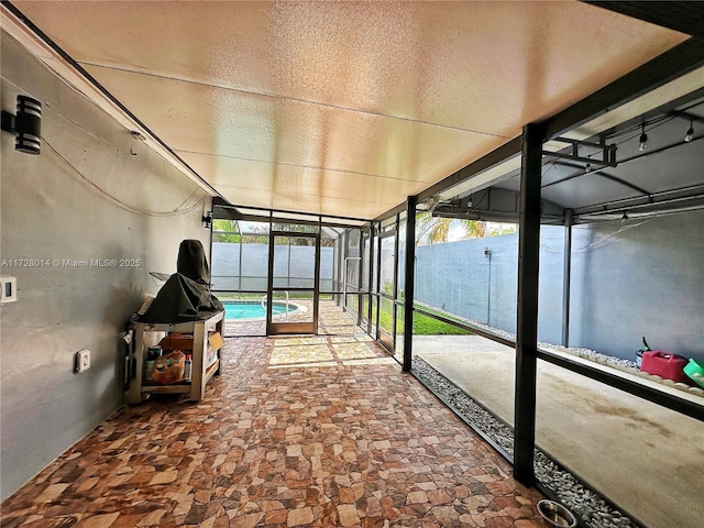 unfurnished sunroom featuring a water view