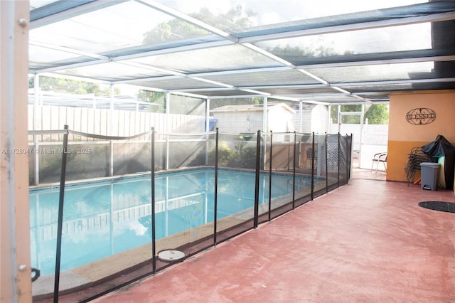 view of swimming pool with a patio area and a storage shed