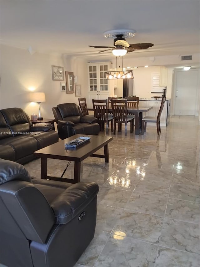 living room with ceiling fan, marble finish floor, and visible vents