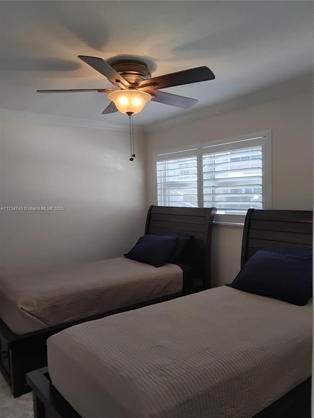 bedroom with ceiling fan and ornamental molding