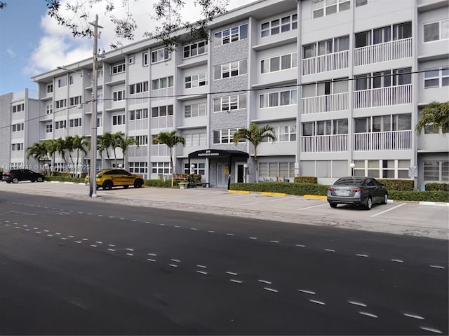 view of building exterior with uncovered parking