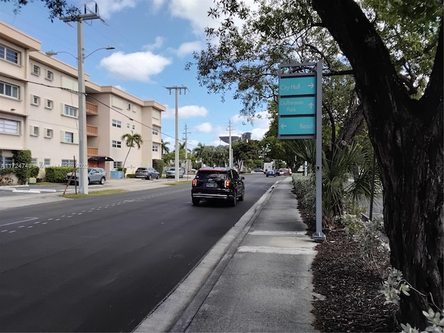 view of street featuring sidewalks, curbs, and street lights