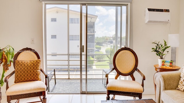 sitting room with tile patterned flooring and a wall mounted AC