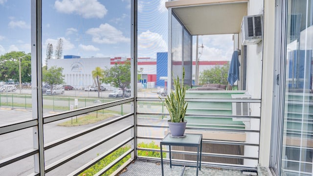 sunroom / solarium with an AC wall unit