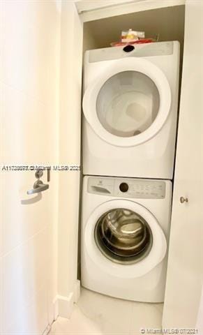 laundry room featuring stacked washer and dryer