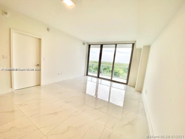 empty room featuring floor to ceiling windows