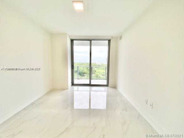 unfurnished room featuring expansive windows