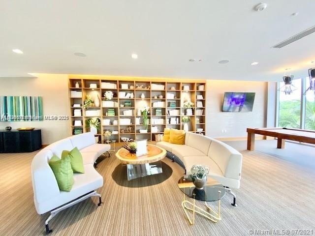 living room with light colored carpet and billiards