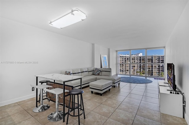 tiled living room featuring expansive windows