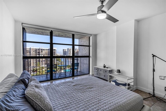 tiled bedroom with ceiling fan, a wall of windows, and access to exterior