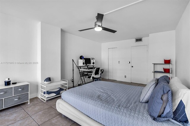 bedroom with ceiling fan and tile patterned flooring