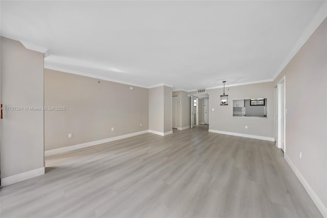 unfurnished living room featuring light wood-type flooring and crown molding