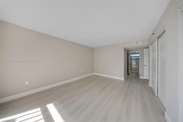 empty room with light hardwood / wood-style floors