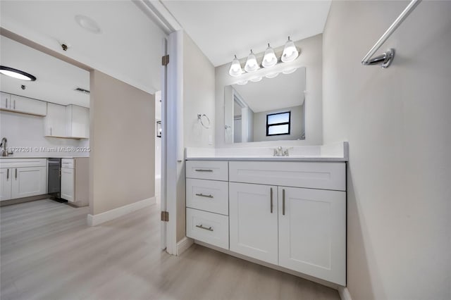 bathroom with hardwood / wood-style flooring, backsplash, and vanity