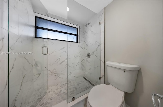 bathroom with an enclosed shower and toilet