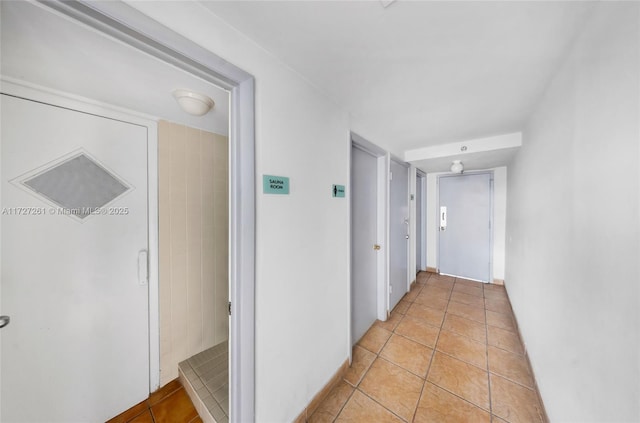 corridor featuring light tile patterned floors