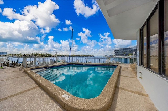 view of swimming pool with a water view