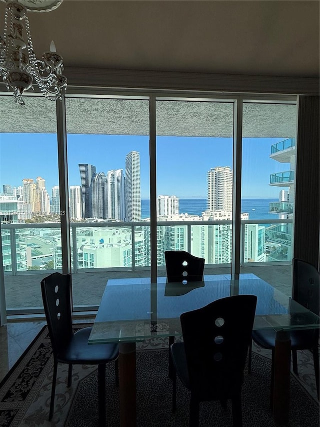 dining room with a healthy amount of sunlight and a water view