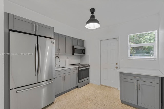 kitchen featuring sink, appliances with stainless steel finishes, gray cabinetry, and tasteful backsplash