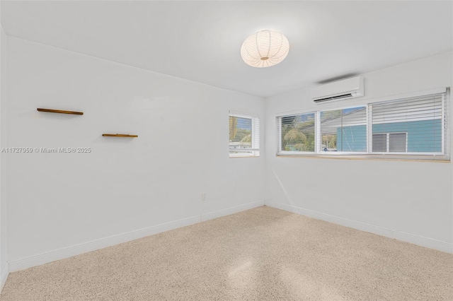 unfurnished room featuring a wall mounted AC