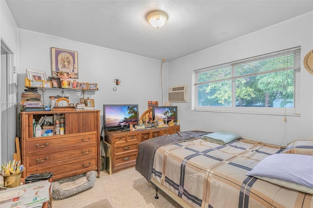 bedroom featuring a wall unit AC and light colored carpet