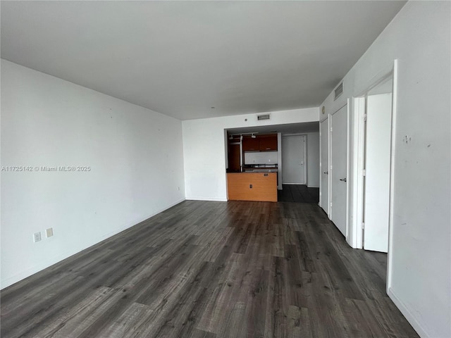 unfurnished living room featuring dark hardwood / wood-style flooring