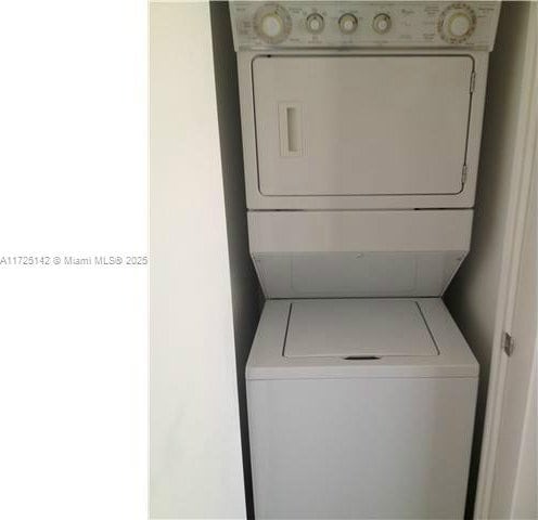 laundry room featuring stacked washing maching and dryer