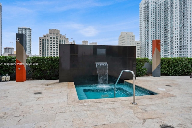 view of swimming pool with a community hot tub