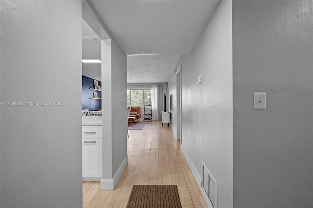 corridor featuring light hardwood / wood-style flooring