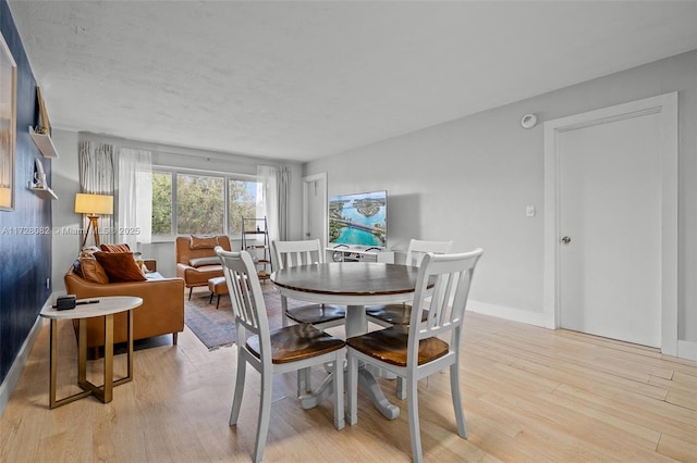 1400 NE 191st St Unit 307, Miami, FL 33179 - dining room featuring light wood-style floors