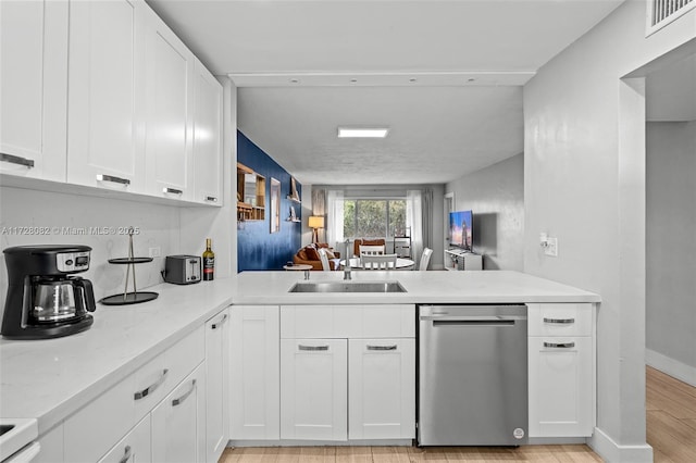 1400 NE 191st St Unit 307, Miami, FL 33179 - kitchen with stainless steel dishwasher, a sink, white cabinets, and light wood finished floors