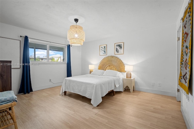 1400 NE 191st St Unit 307, Miami, FL 33179 - bedroom with light wood-type flooring and baseboards
